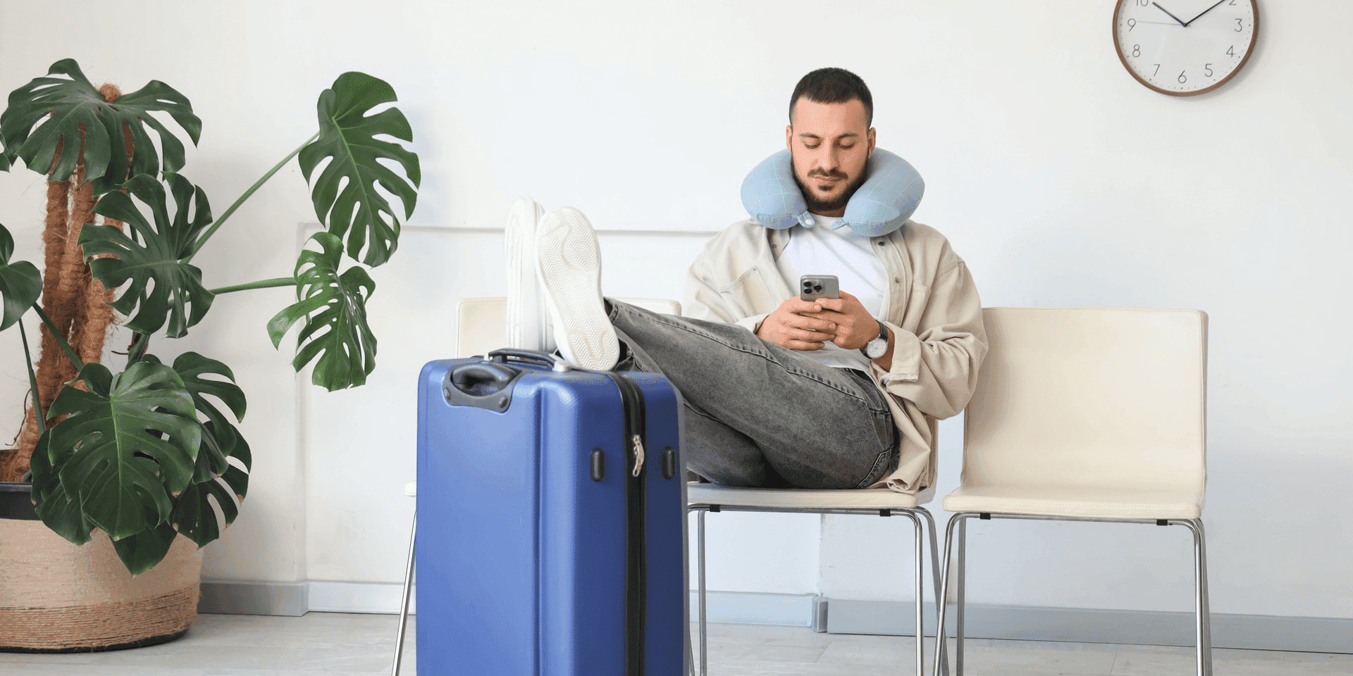 Traveller at an airport using a mobile phone